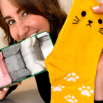 woman holds a set of cat socks